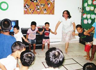Teacher Margaret joins with the fun at the Hand to Hand center.